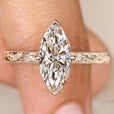 Marquise diamond ring with hidden round diamond halo.
