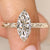 Marquise diamond ring with hidden round diamond halo.
