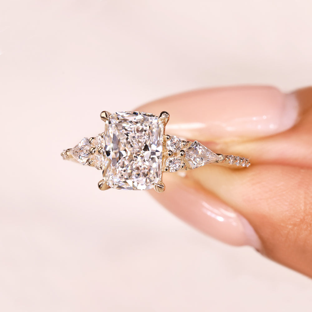Cushion diamond ring with four claw prongs and accents.
