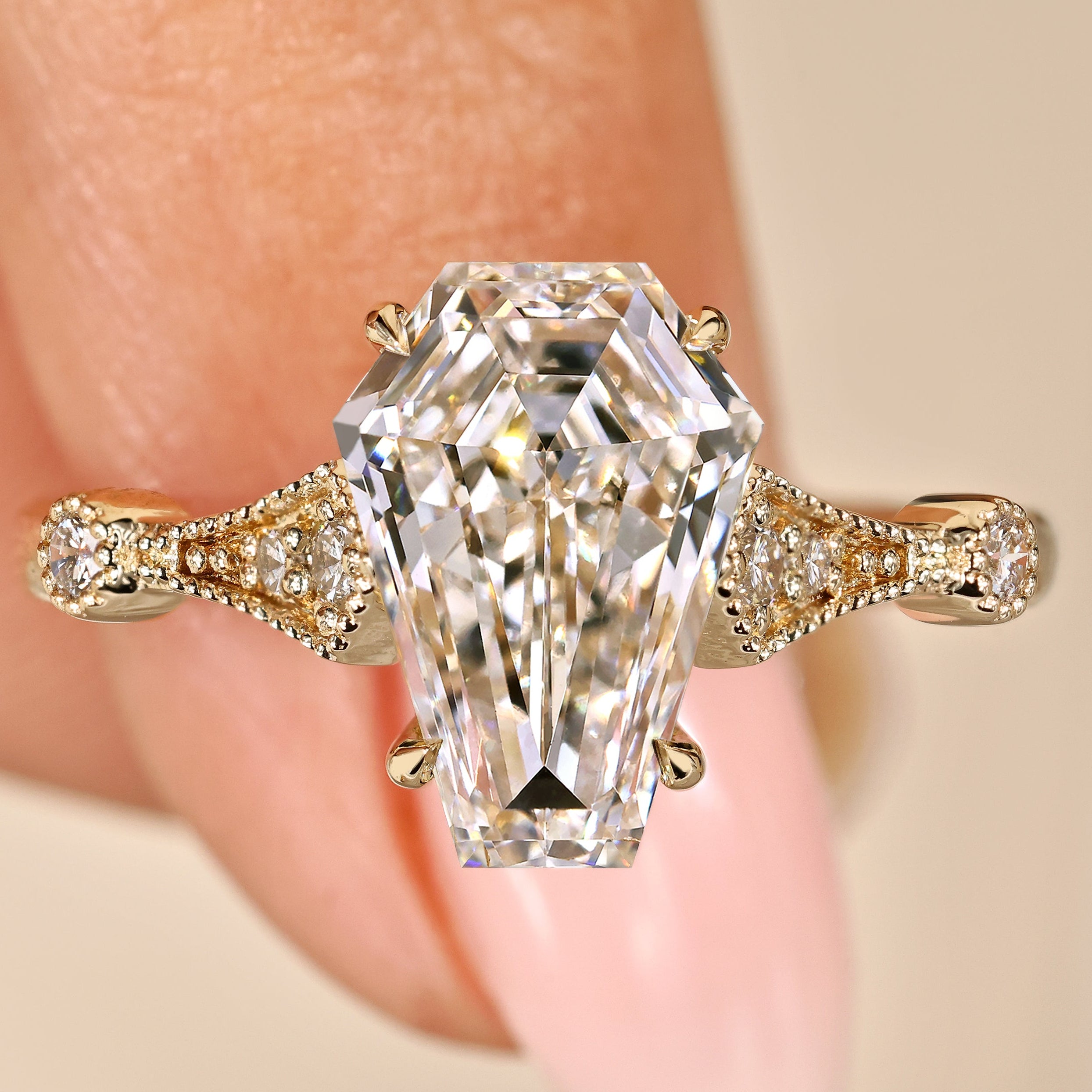 Coffin cut engagement ring with round side stones design
