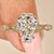 Coffin cut engagement ring with round side stones design
