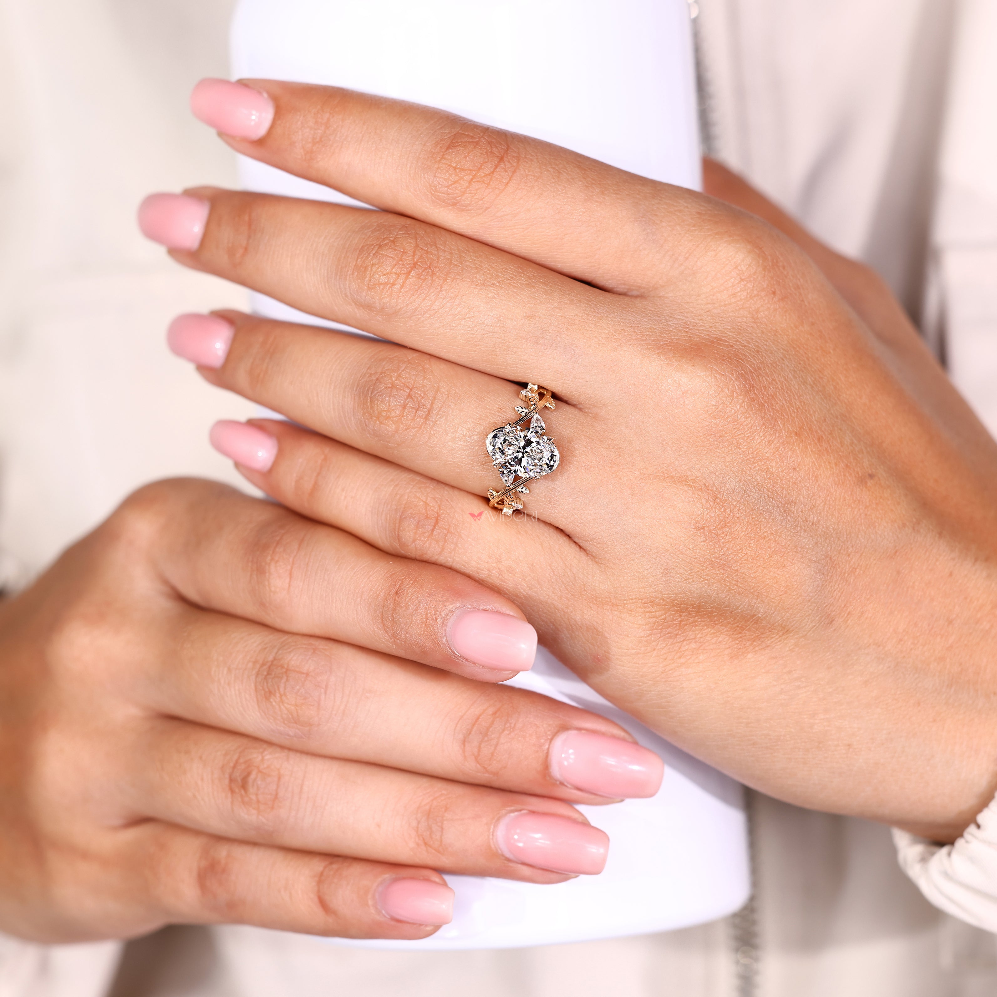 Oval diamond ring with pear and round side stones
