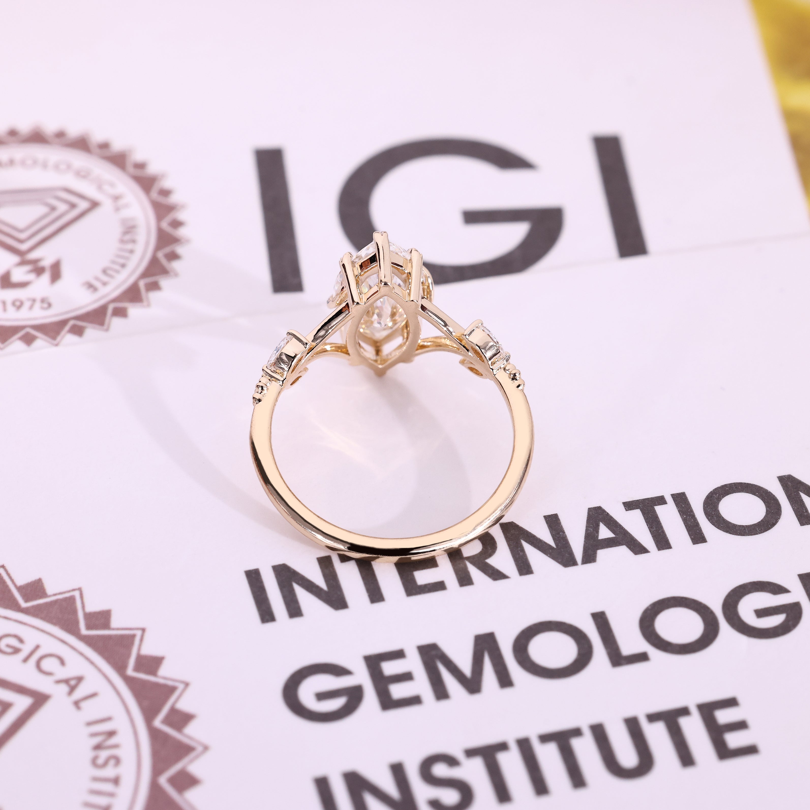 Handmade marquise engagement ring with round side stone accents
