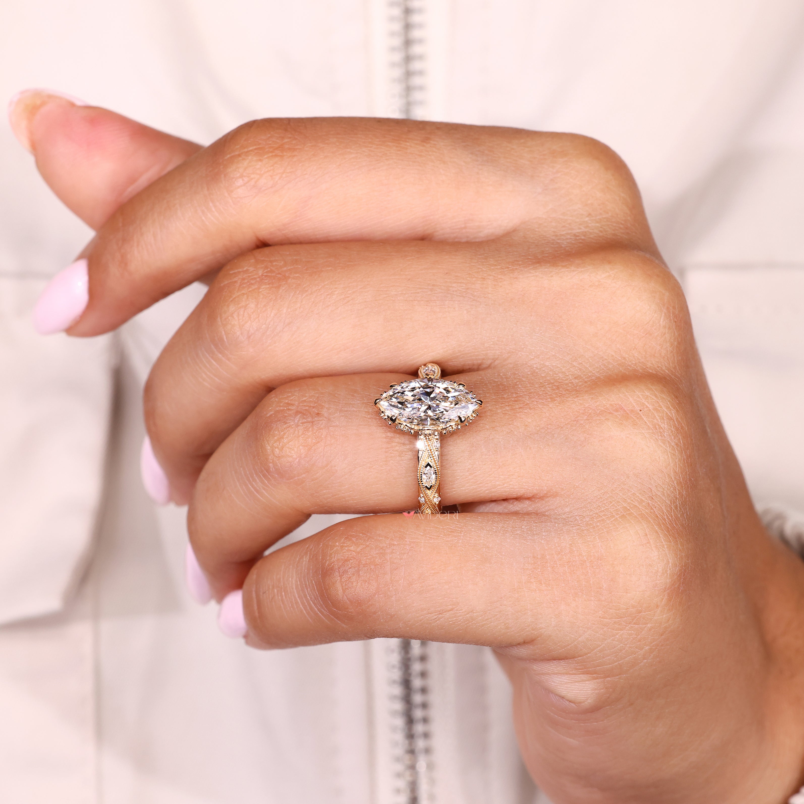 Handmade marquise ring with round diamonds and hidden halo
