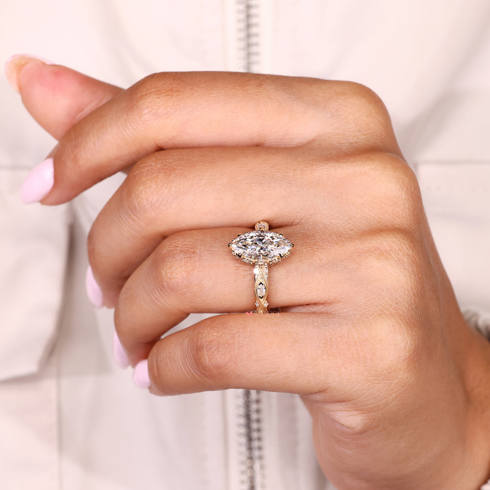 Handmade marquise ring with round diamonds and hidden halo
