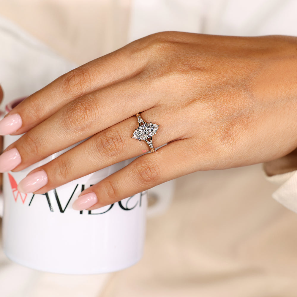 Marquise diamond engagement ring with round side stones
