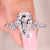 Coffin cut diamond engagement ring with round side stones.