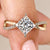 Princess cut diamond ring with pave diamond band in elegant twist design.

