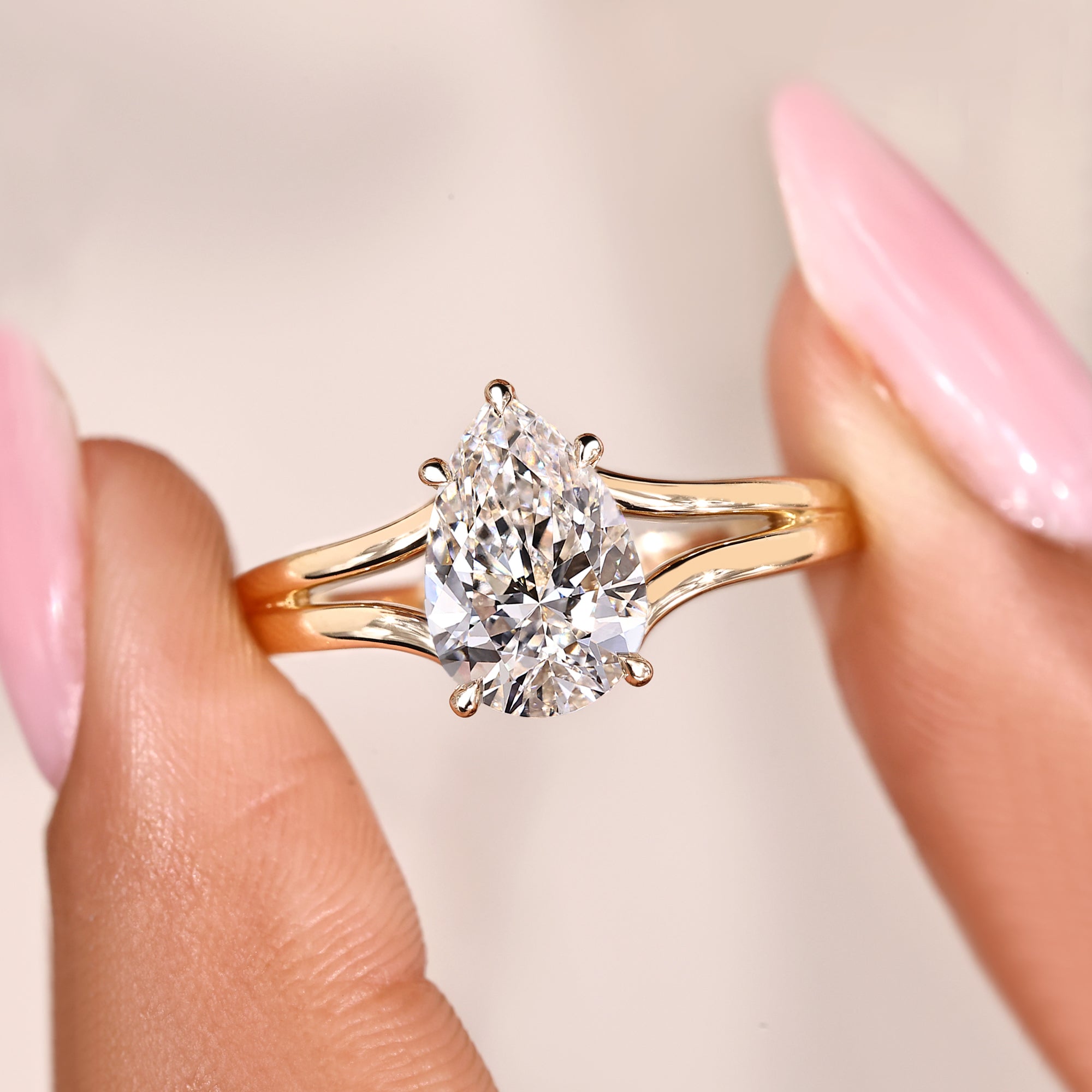 Handmade pear cut diamond ring with split shank and hidden halo design.