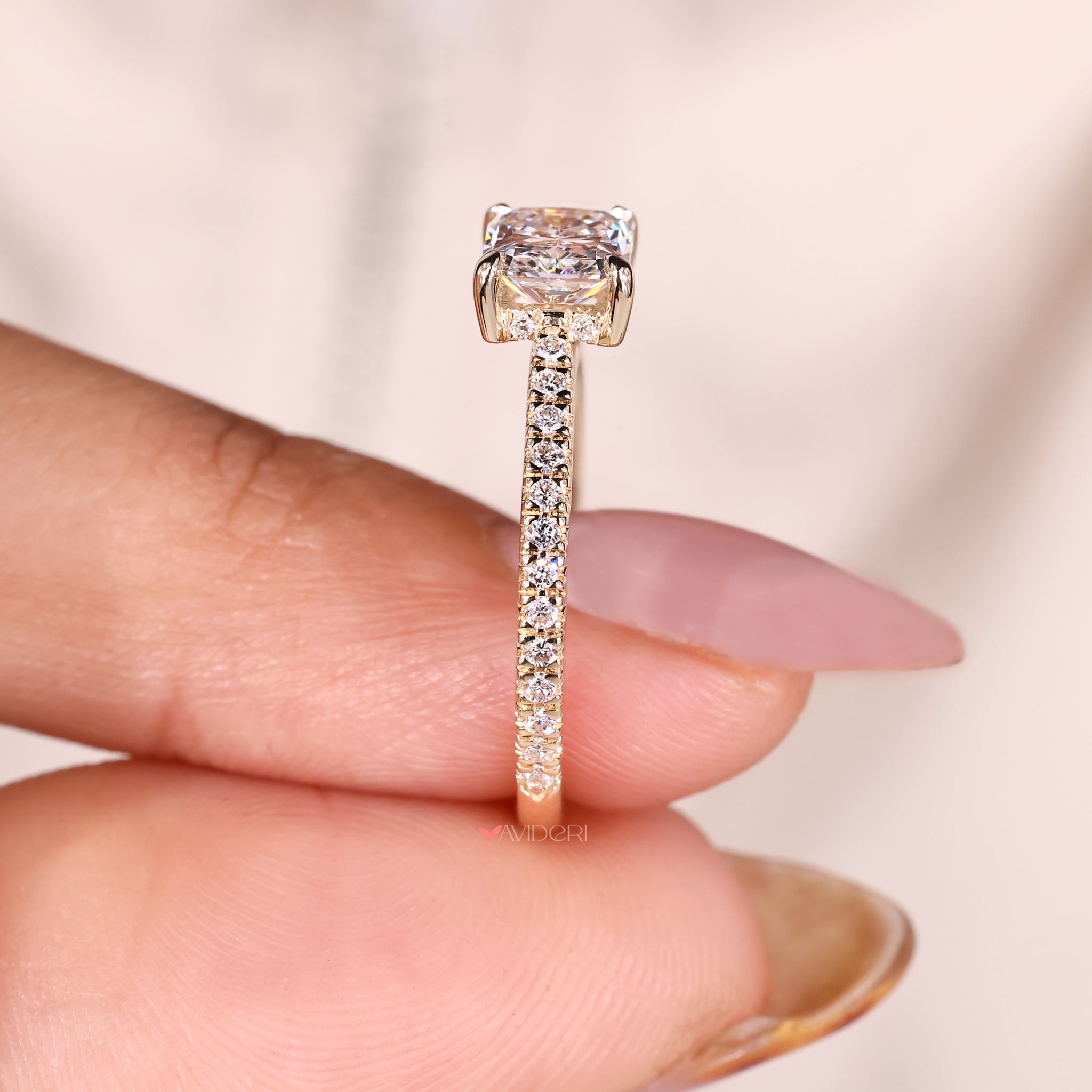 Pave round diamond ring with 4-prong claw setting.