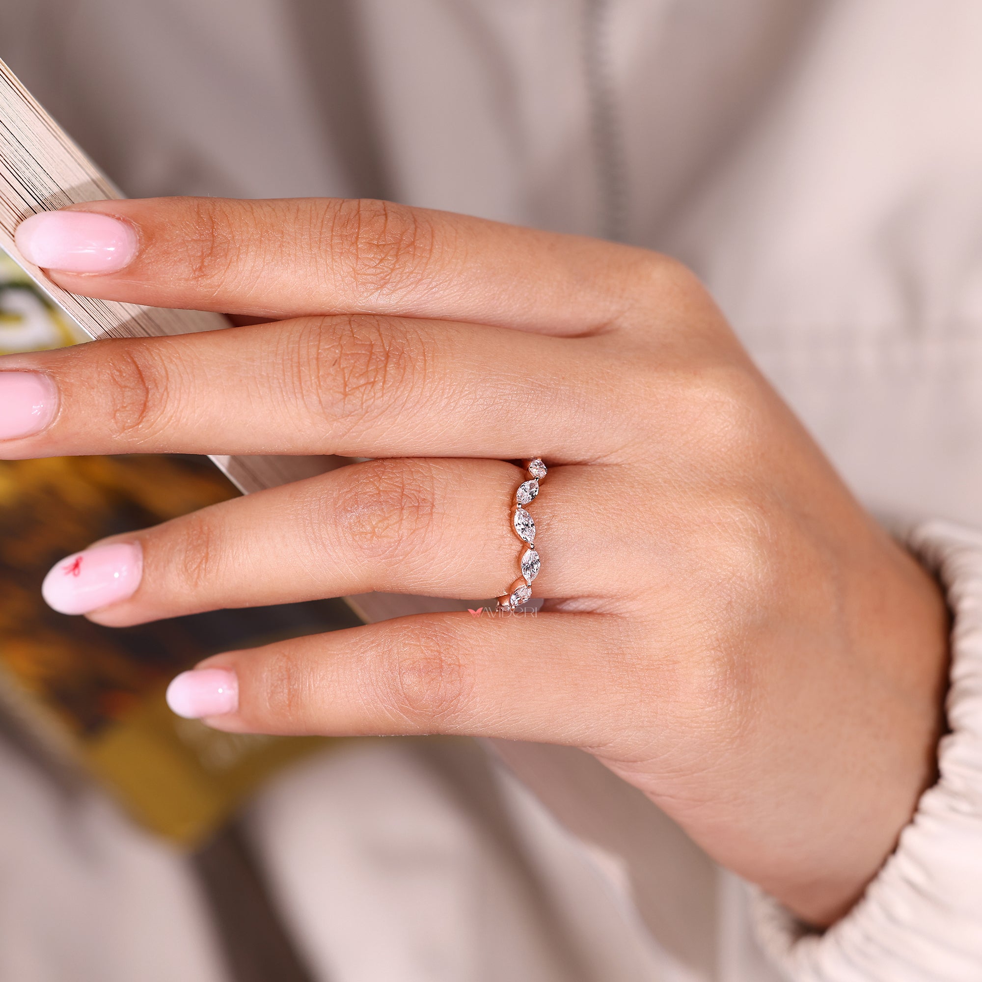 Marquise diamond wedding band with curved design.

