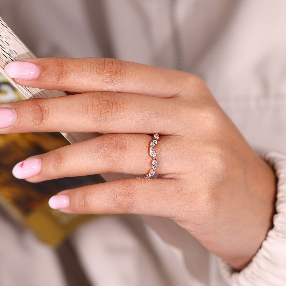 Marquise diamond wedding band with curved design.
