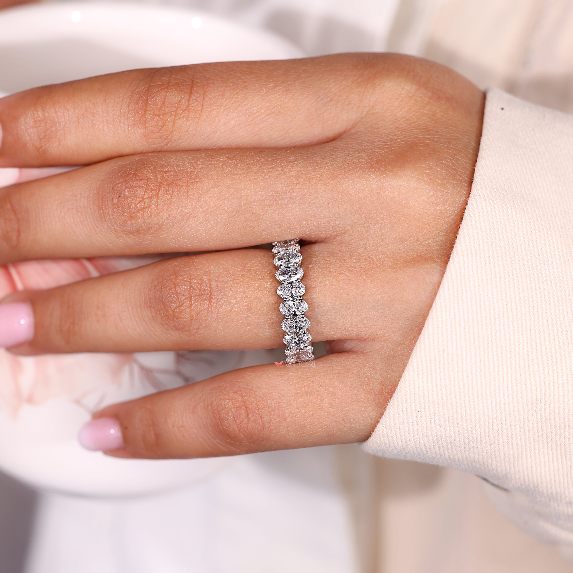 Oval cut diamond band with shared prong.