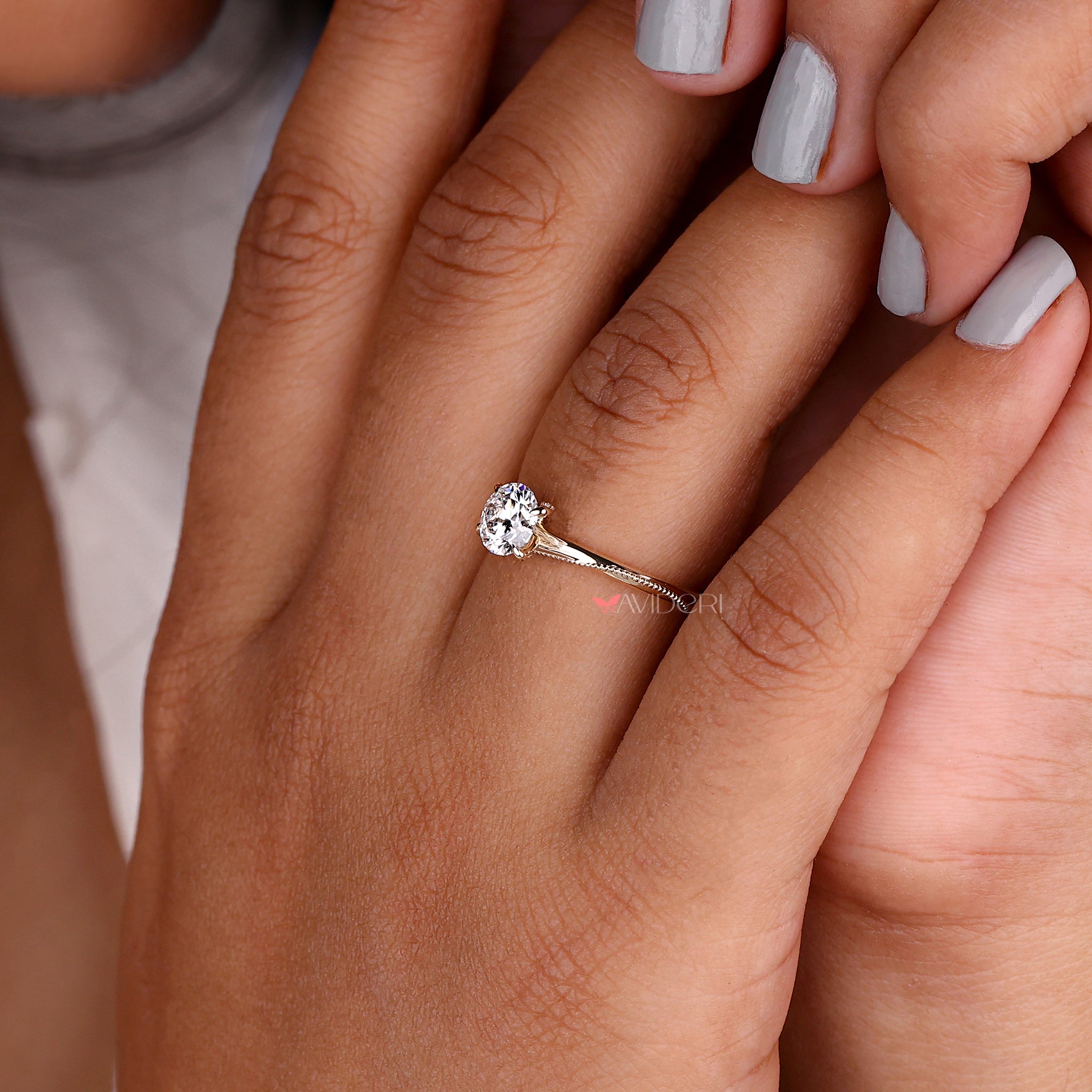 Lab diamond engagement ring with intricate milgrain details in a gold solitaire engagement ring design.
