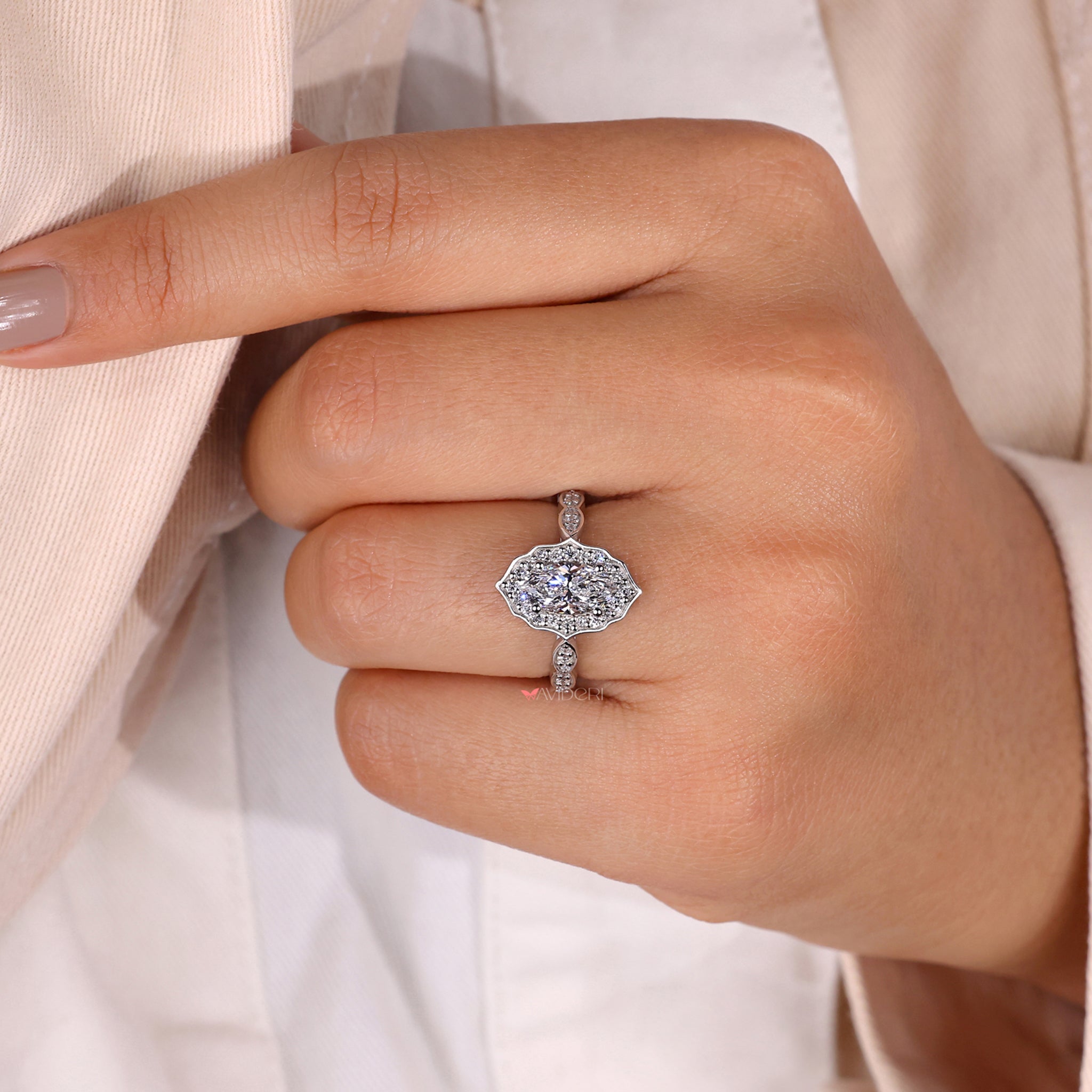 Halo diamond engagement ring with an Avideri ring.

