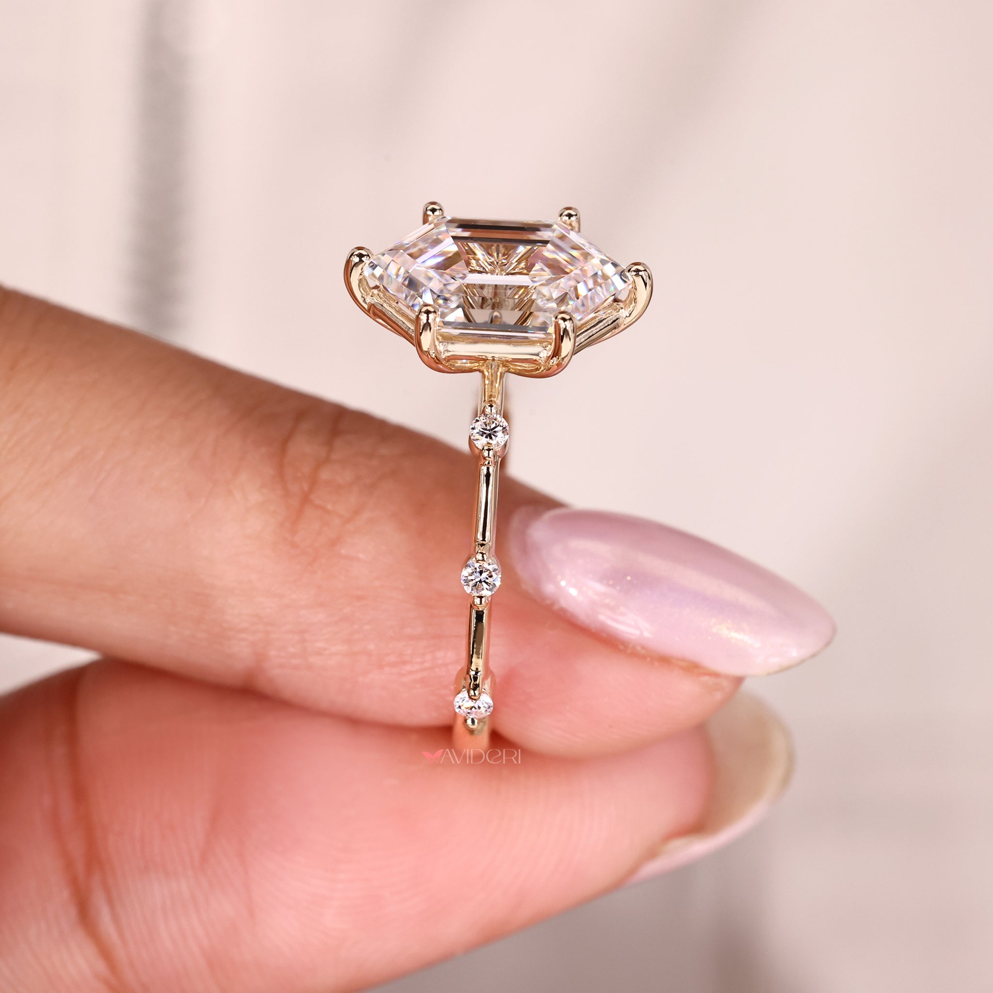 Unique engagement ring featuring a hexagon step cut and round side stones