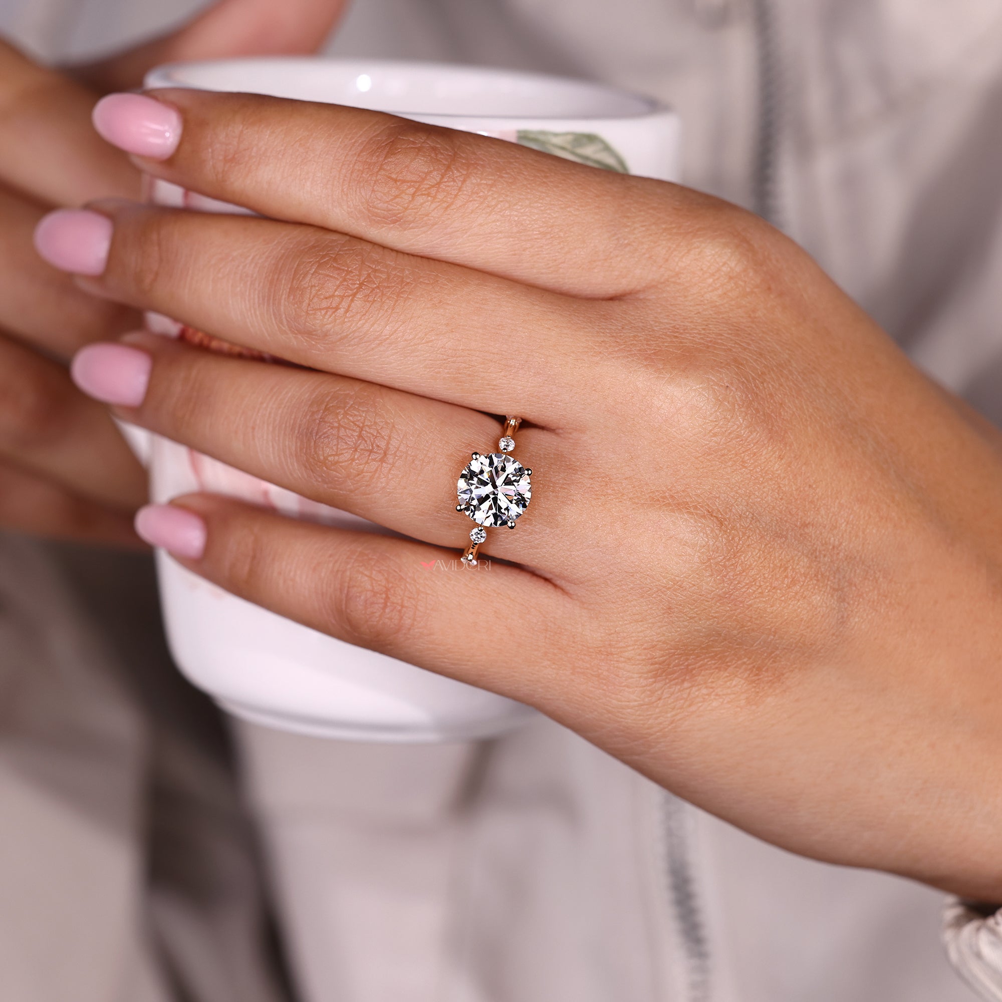 Round diamond ring with distance pave band.
