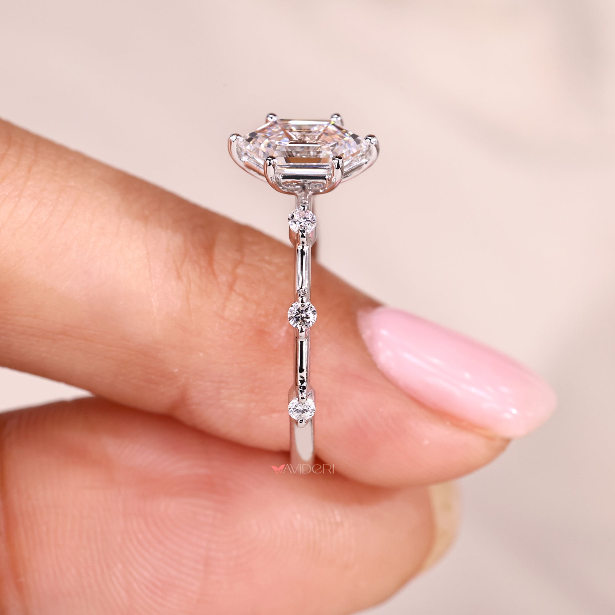 Round cut side stone with white gold engagement ring.