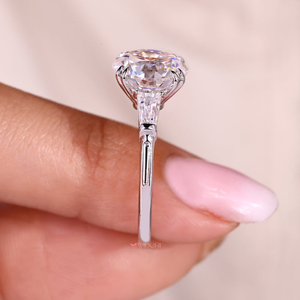 Round moissanite ring in three stone style design.
