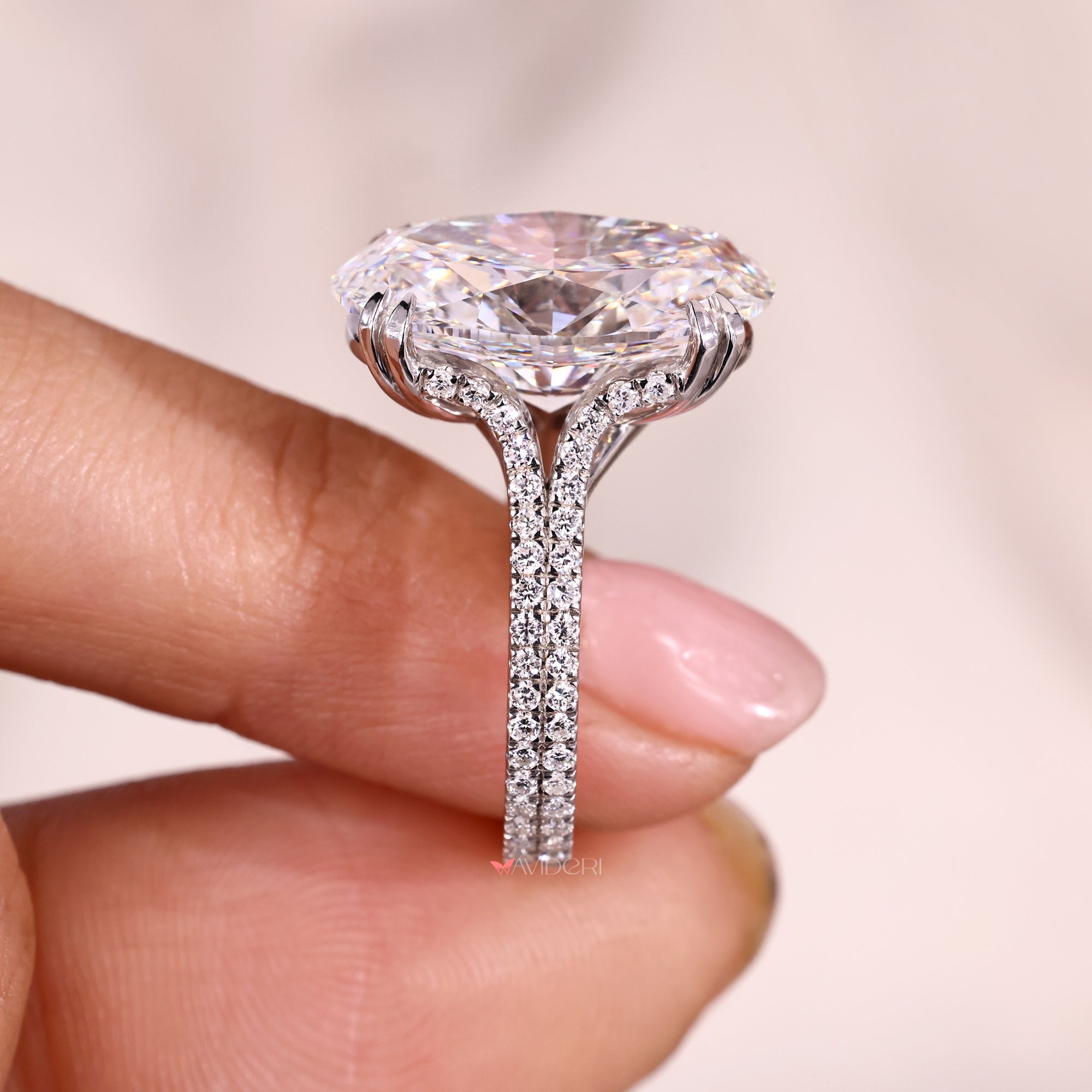 Cathedral setting oval diamond ring with round cut diamond pave band.