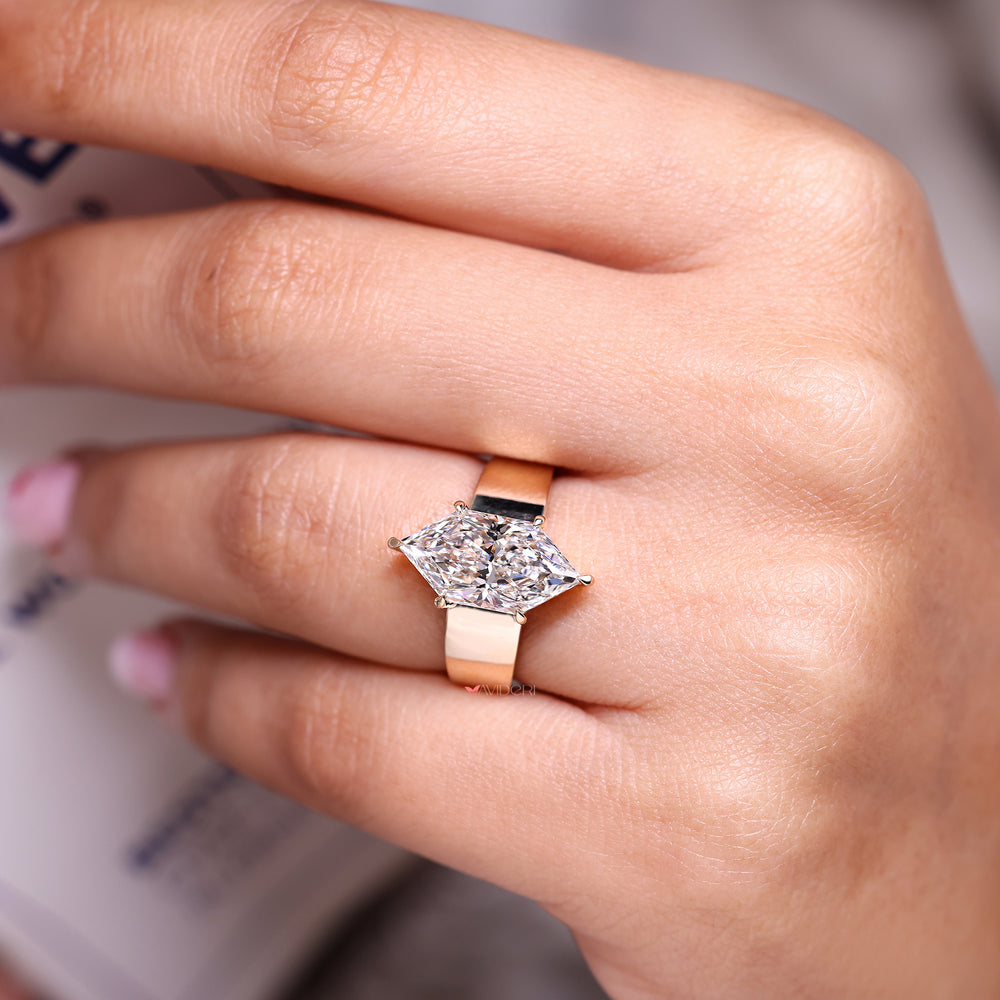 Solitaire dutch marquise diamond ring with tapered shank.
