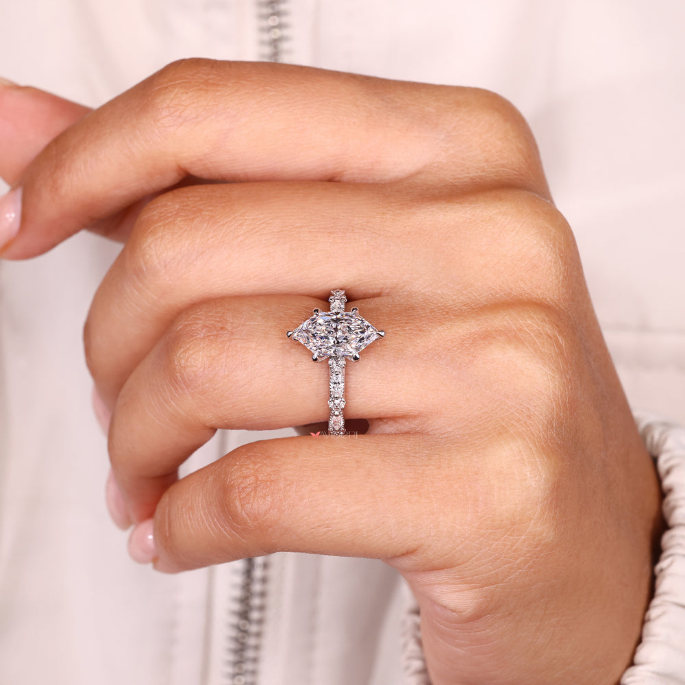 Vintage style marquise ring with round side stone accents.
