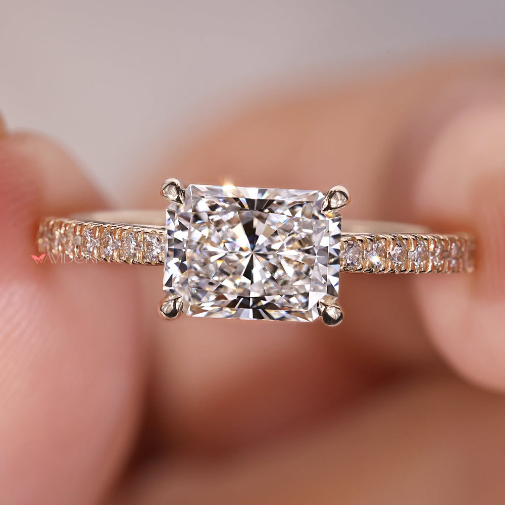 Radiant cut diamond engagement ring with pave round diamonds.