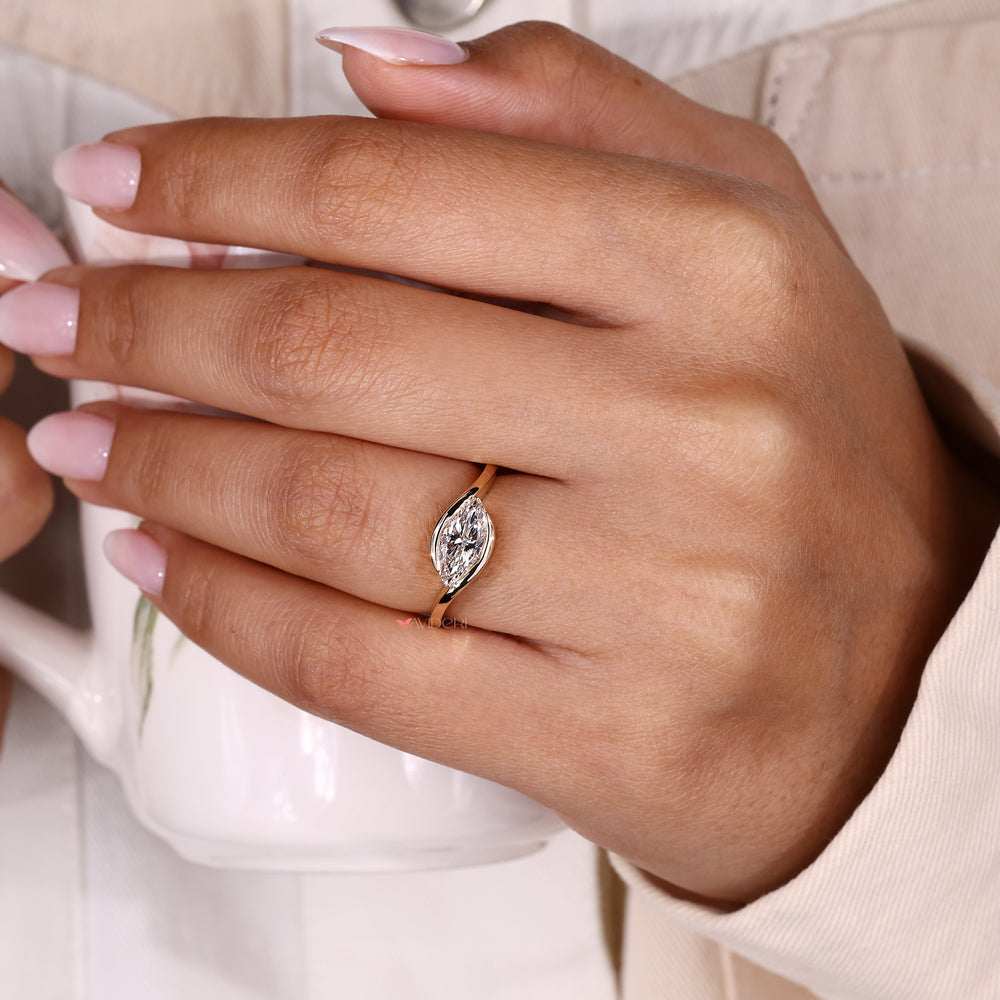 Marquise solitaire ring with bypass setting.
