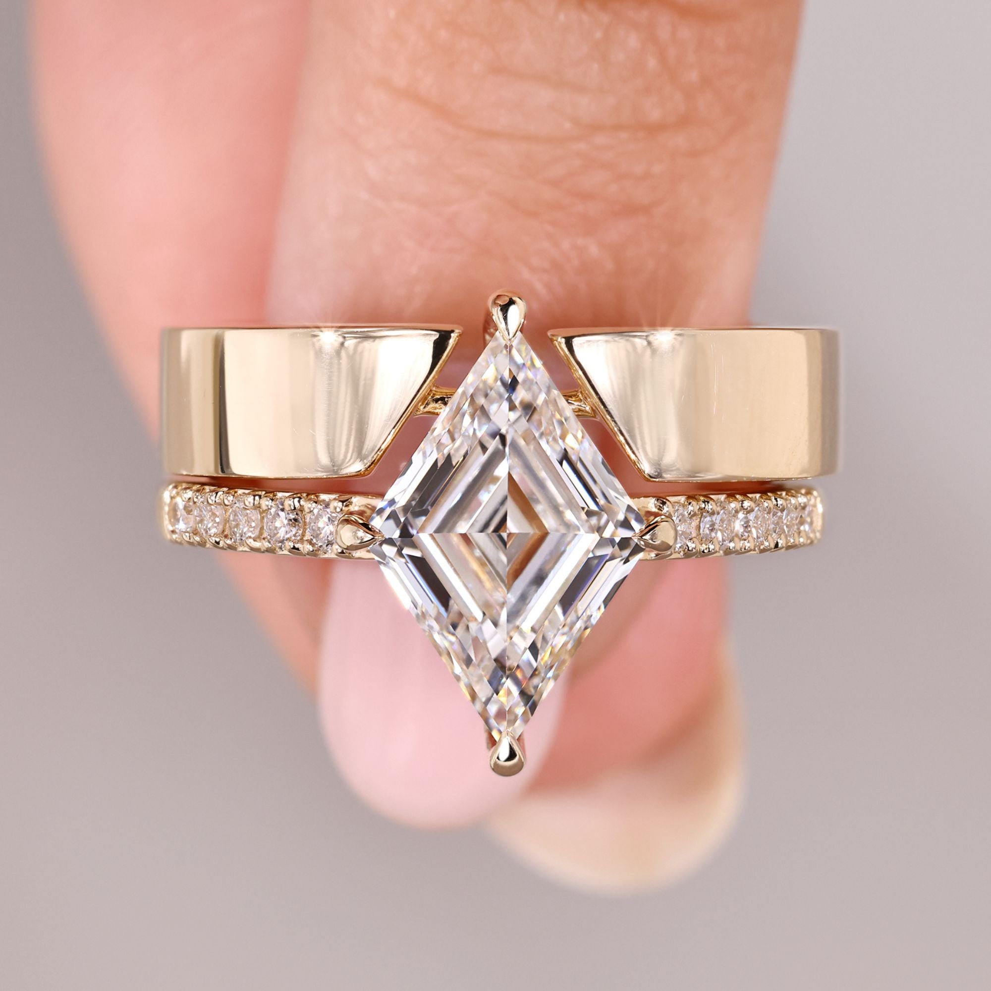 Lozenge cut diamond ring with pave band and wedding band.