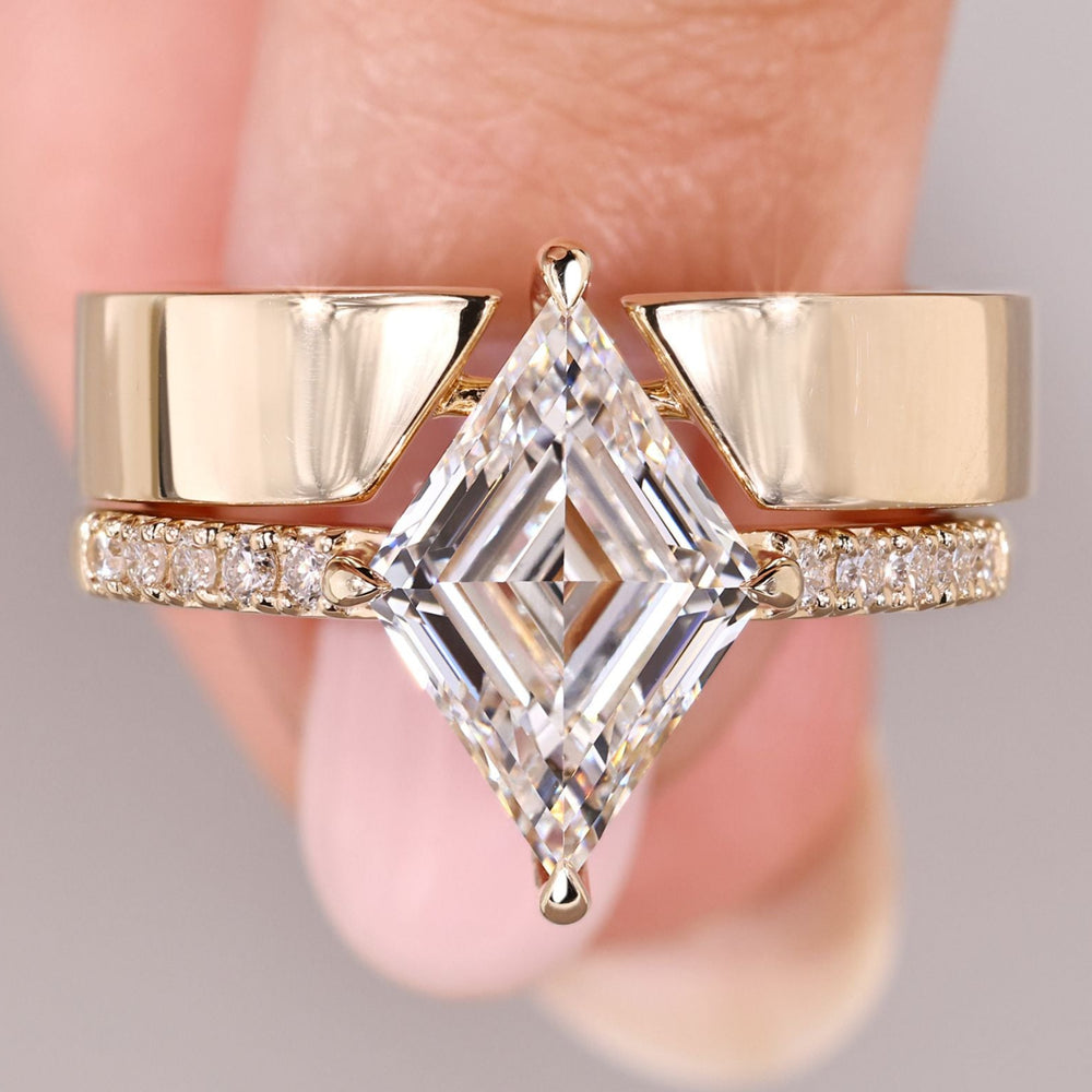 Lozenge cut diamond ring with pave band and wedding band.