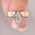 Lozenge cut diamond ring with pave band and wedding band.