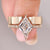 Lozenge cut diamond ring with pave band and wedding band.