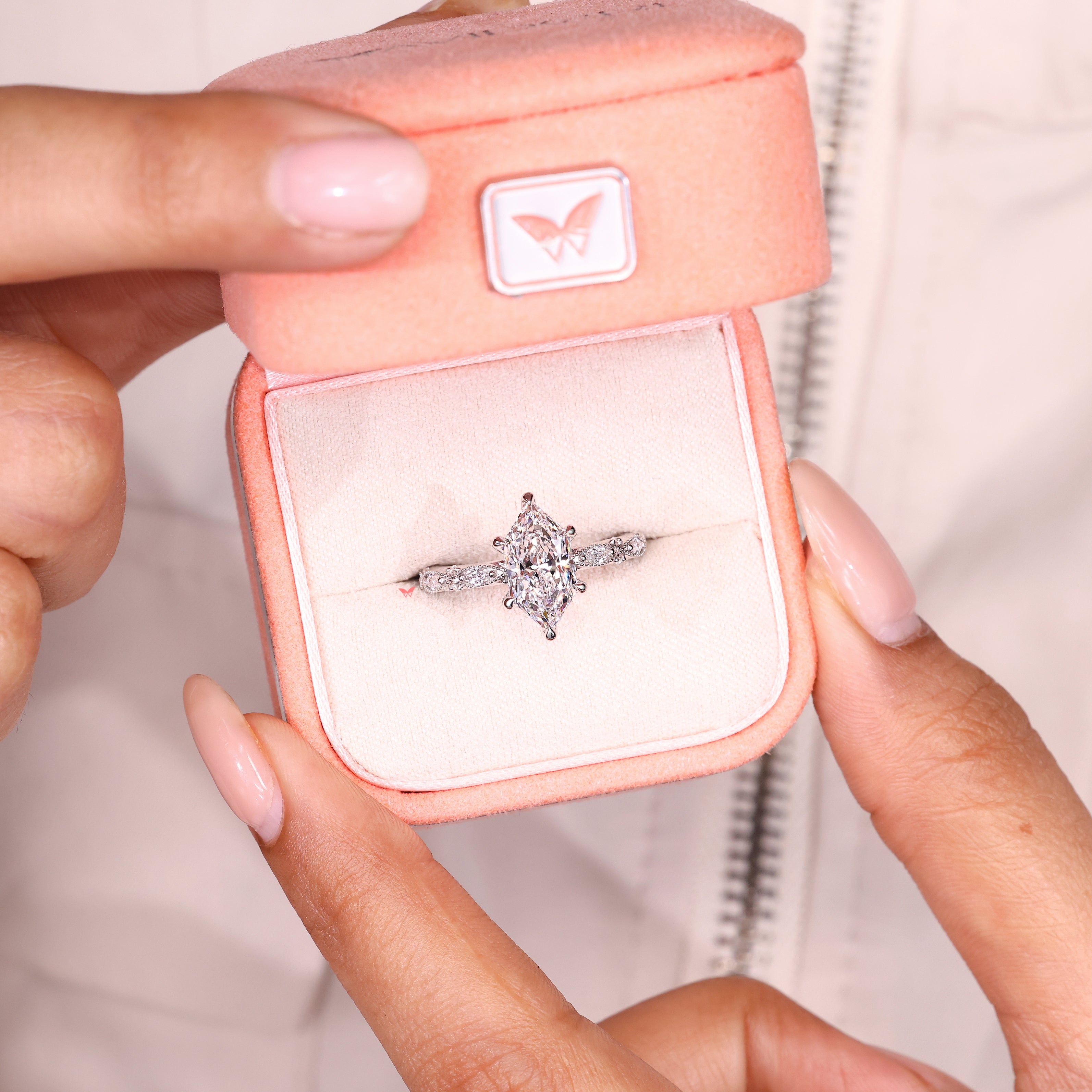 Lab grown marquise diamond ring with six claw prongs.
