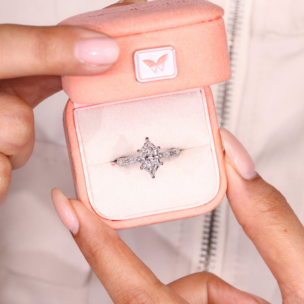 Lab grown marquise diamond ring with six claw prongs.
