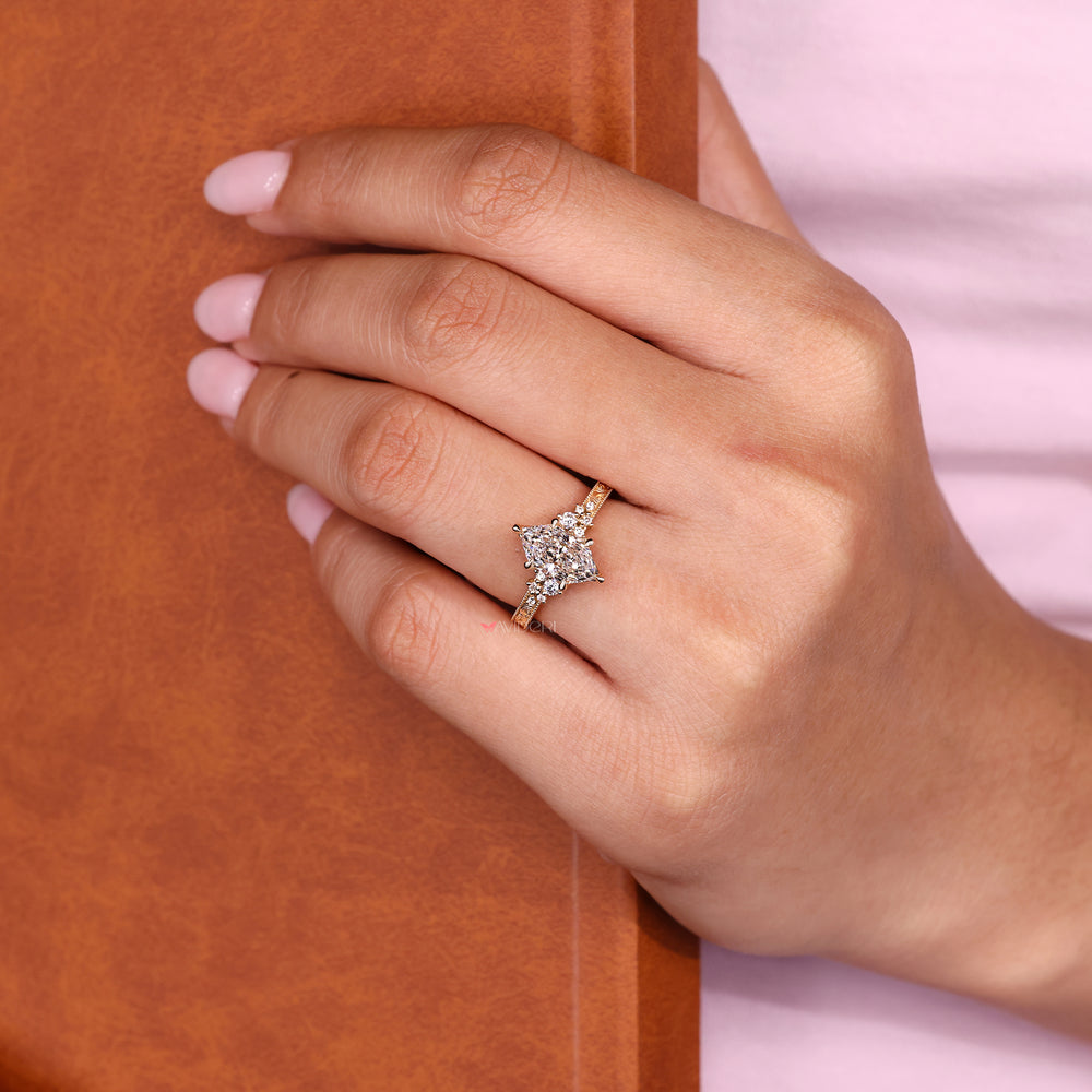 Marquise ring with round side stones design.

