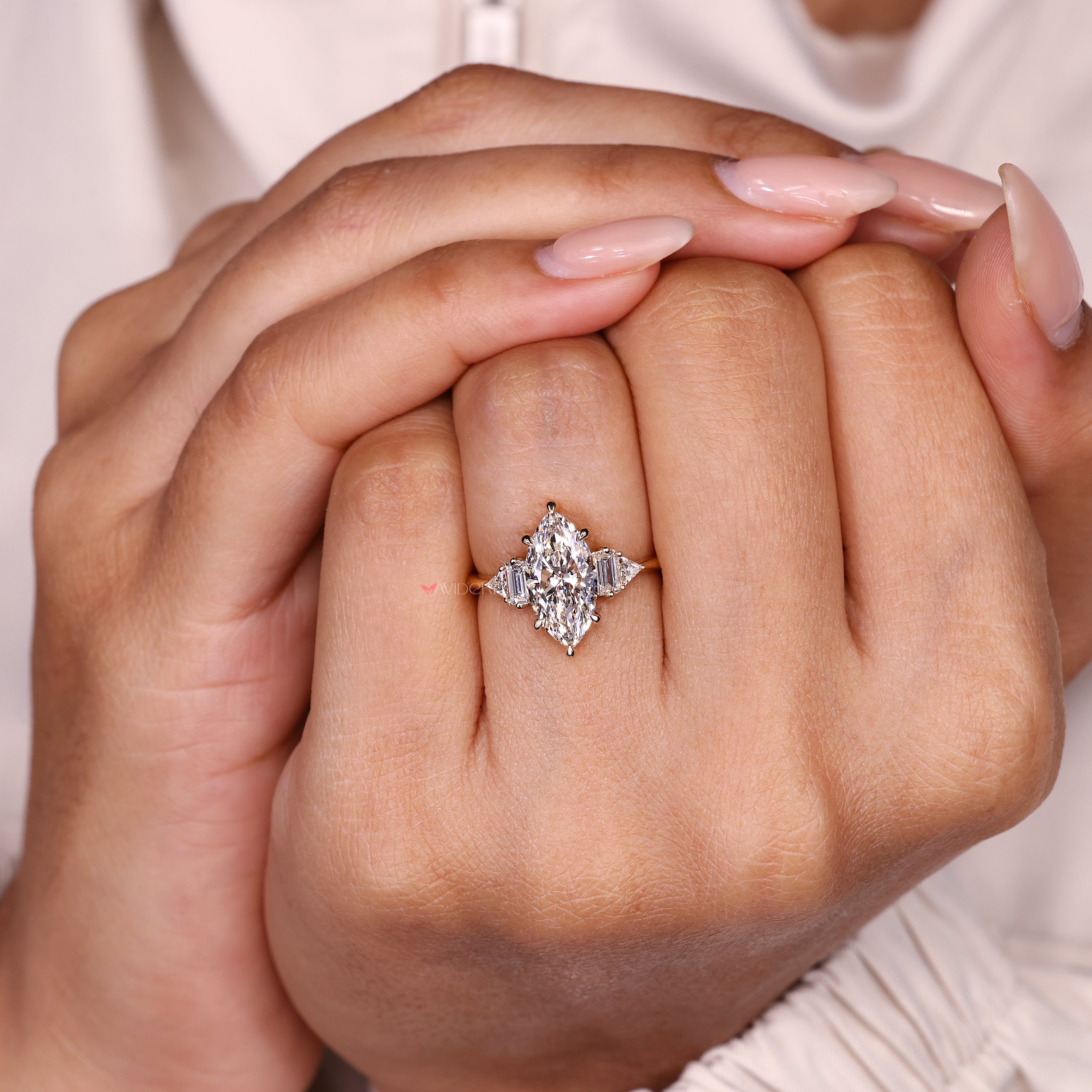 Marquise engagement ring with triangle accents and baguette stones.
