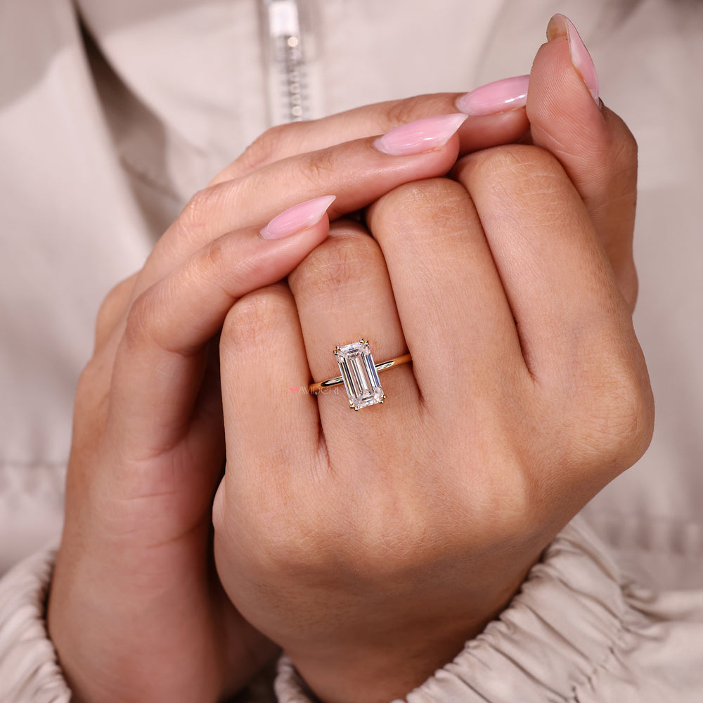 Emerald cut moissanite ring with refined prong detail.
