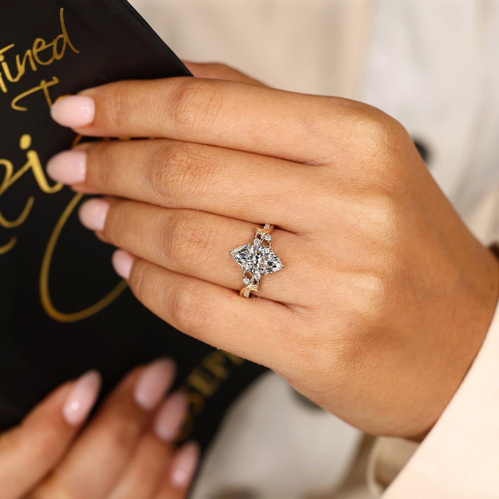Handmade marquise diamond ring with leaf prongs and accents
