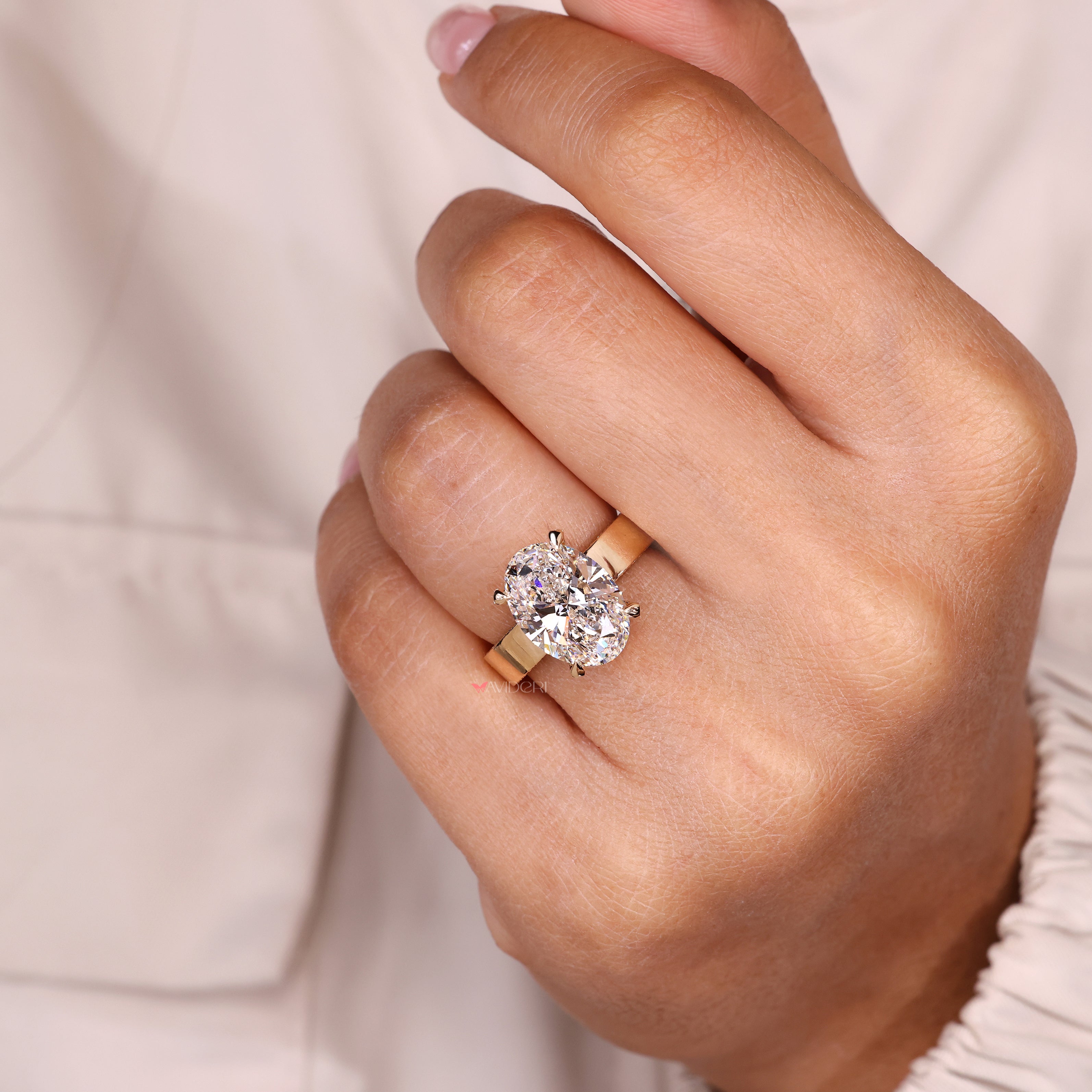Oval cut ring with hidden halo pave design.
