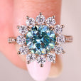 Round moissanite ring with prong and pave setting.
