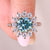 Round moissanite ring with prong and pave setting.
