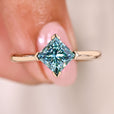 Princess cut moissanite ring cyan blue solitaire.
