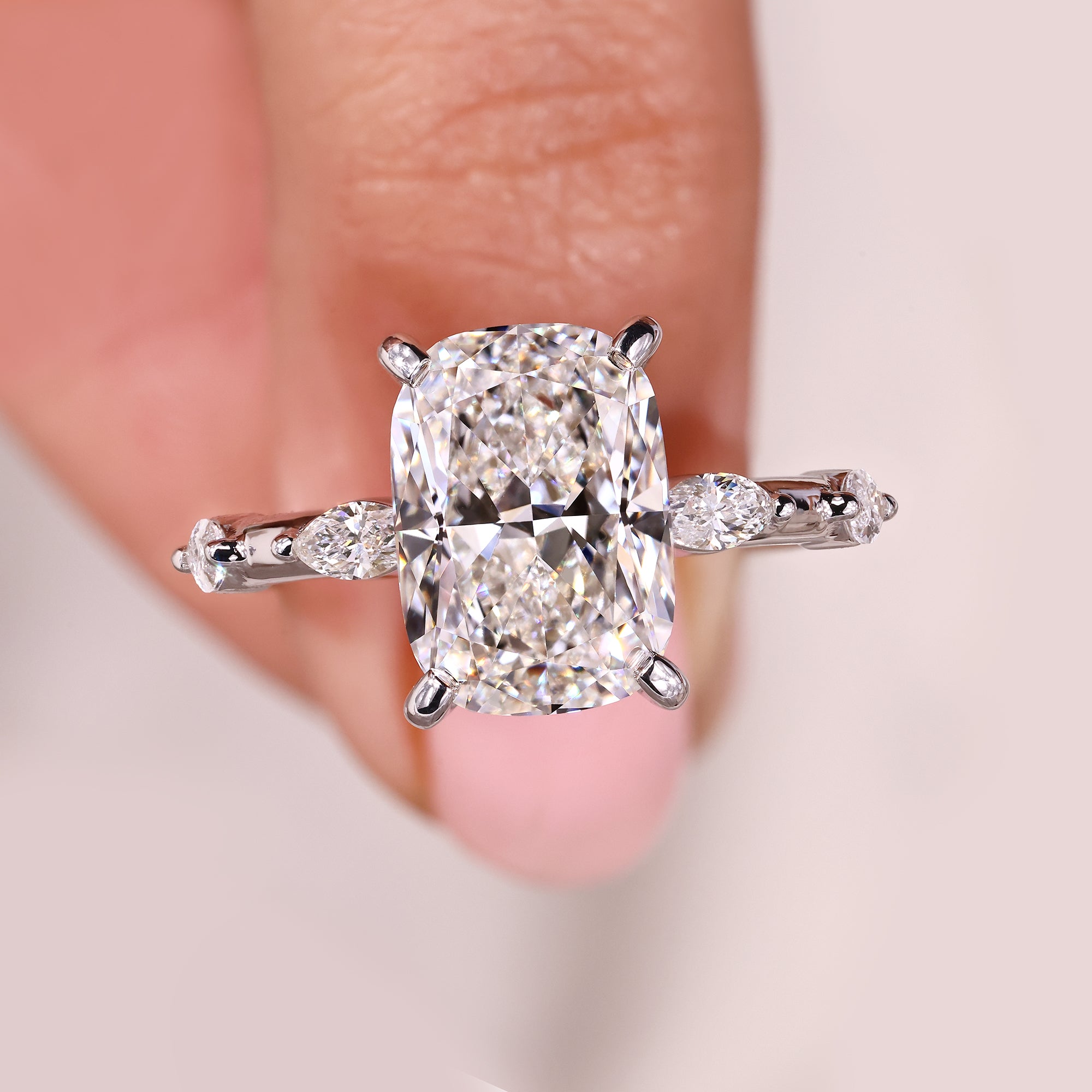 Elongated cushion engagement ring with a bright center diamond.