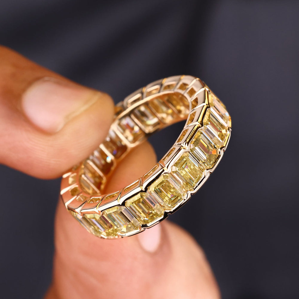 Emerald mens wedding ring in half bezel setting.