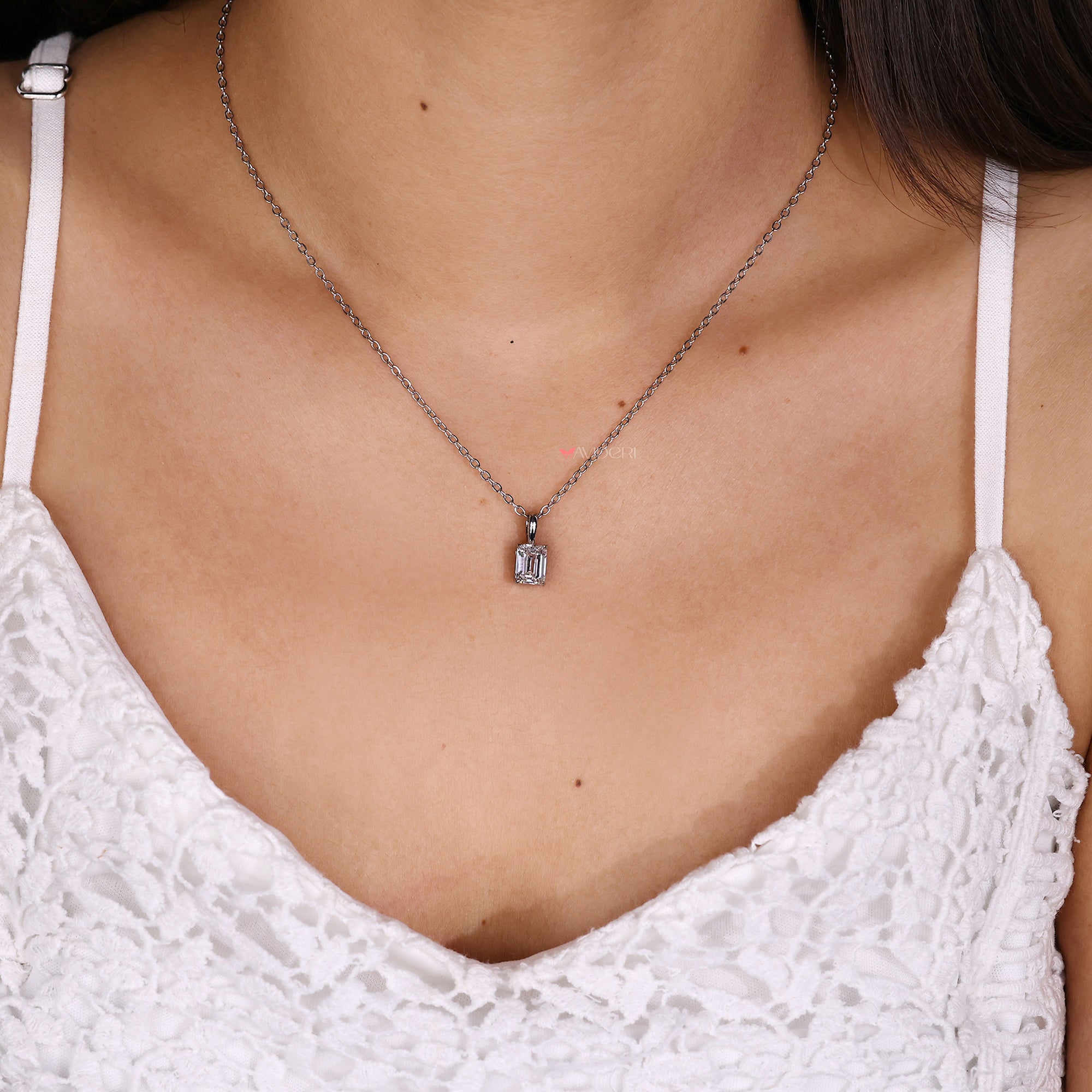 Fancy pendants showcasing emerald solitaire diamond settings.