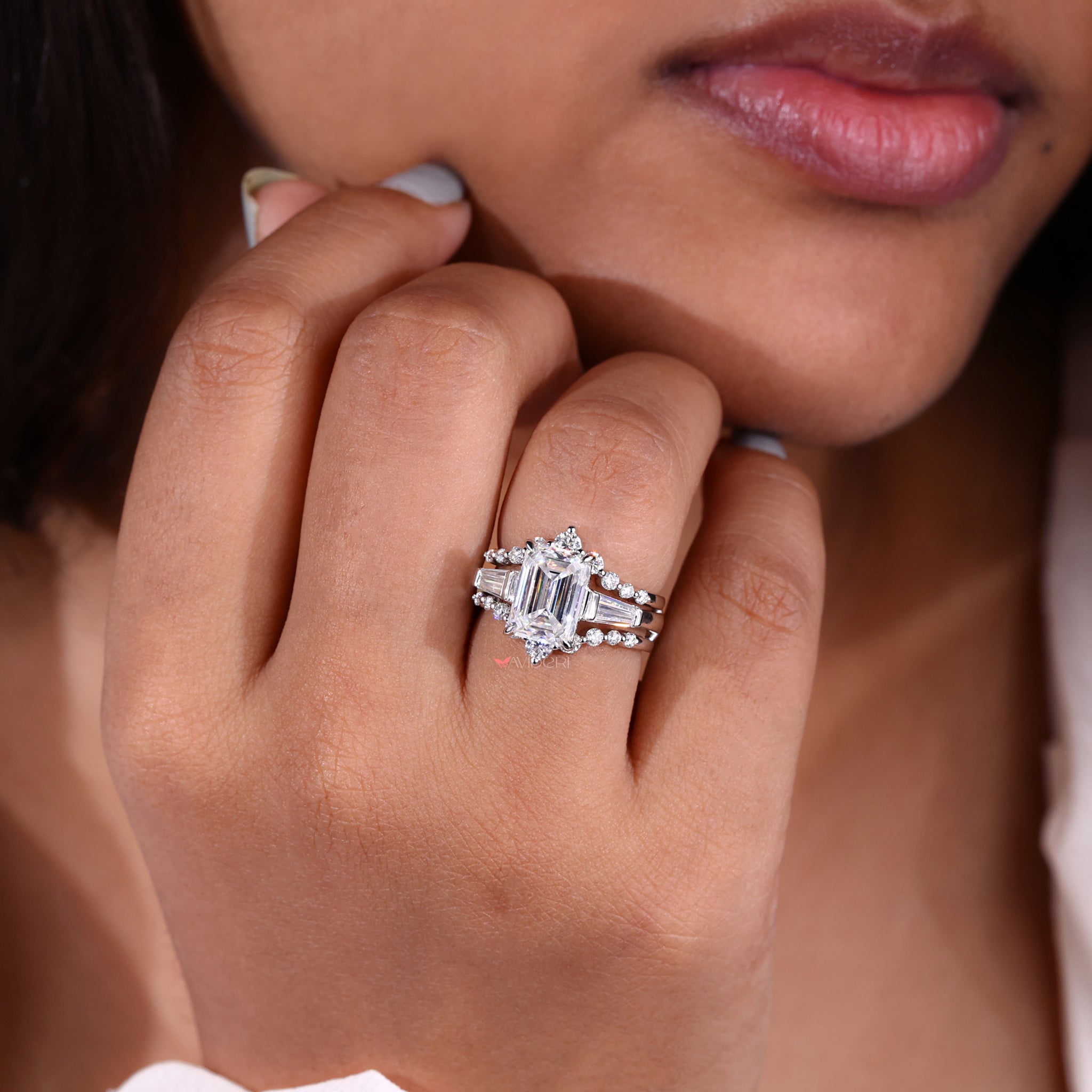 Three stone engagement ring with tapered baguettes.