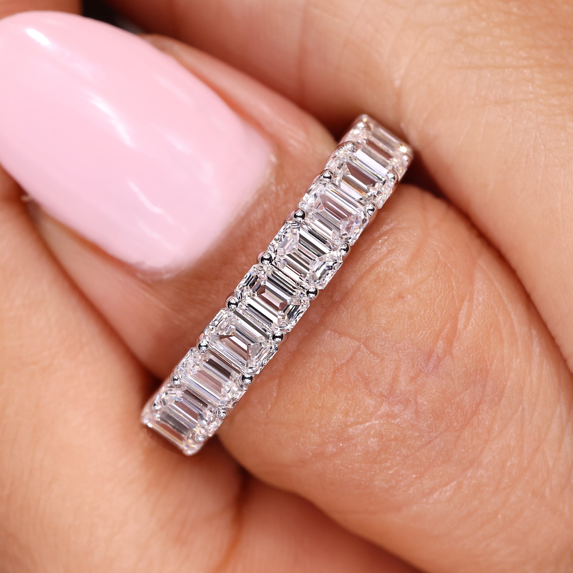 Emerald cut diamond band with clean shared prongs.
