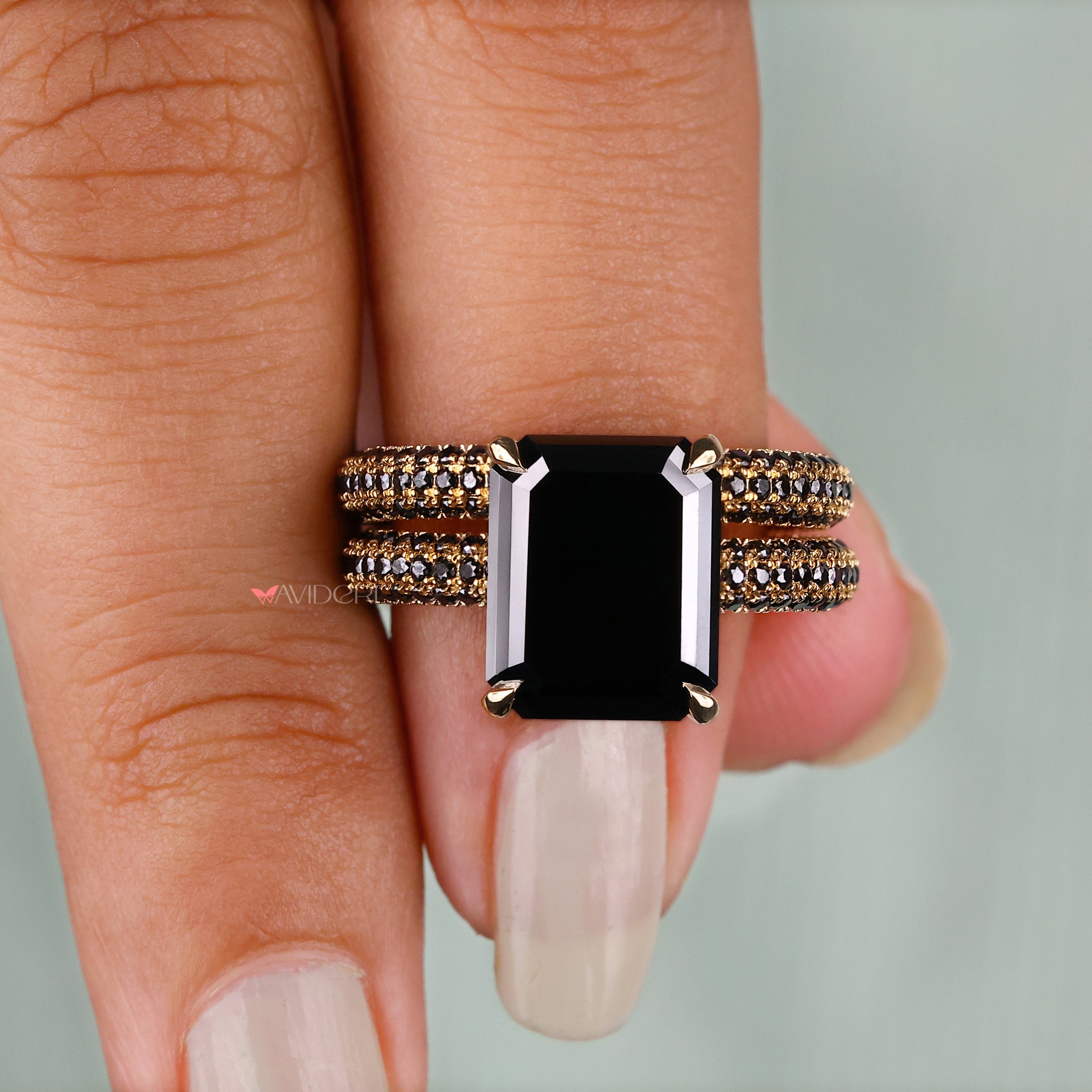 4 claw prong ring with an emerald cut moissanite stone for a secure setting.