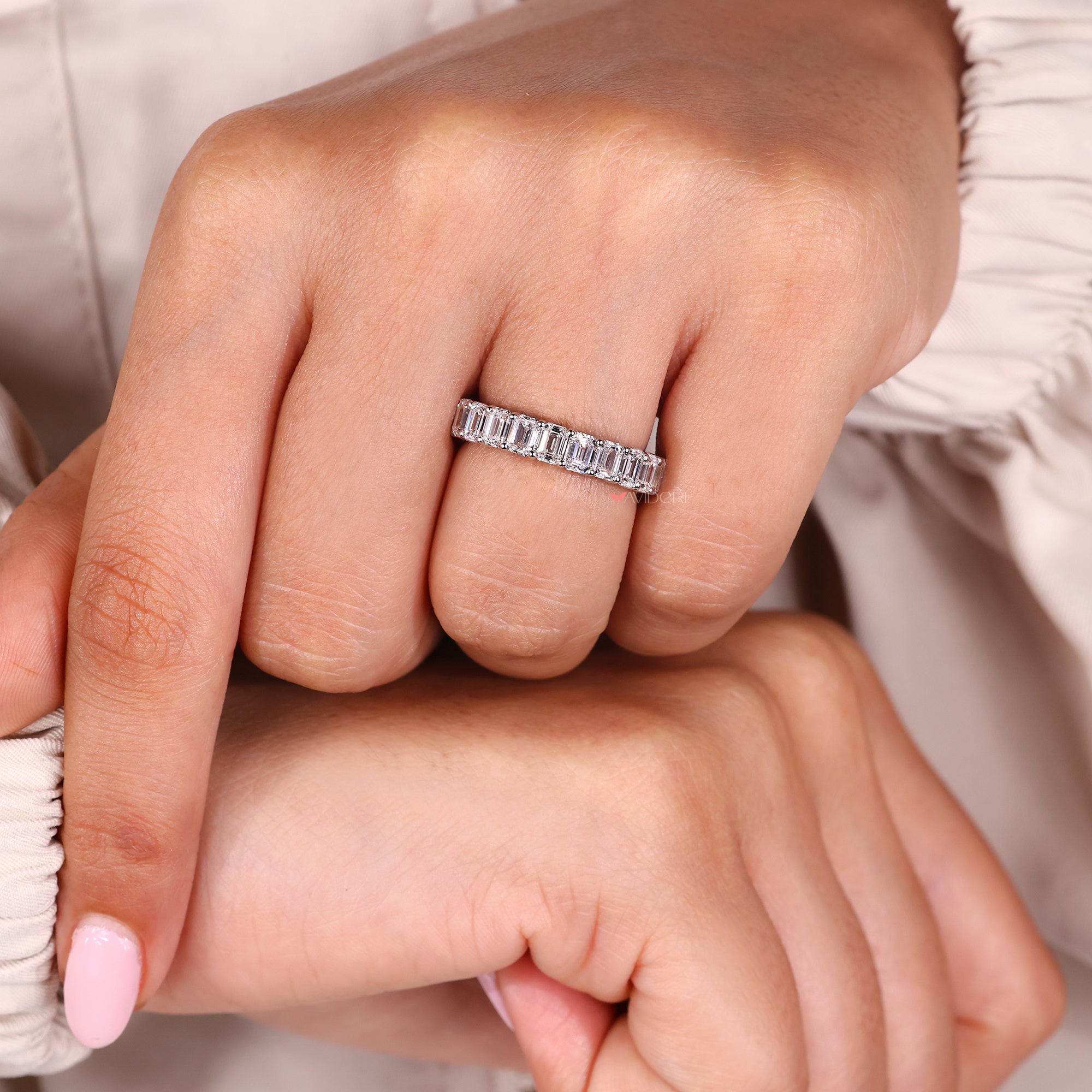 Shared prong emerald cut diamond band eternity style.
