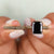 Emerald cut moissanite ring with an emerald cut engagement ring setting.